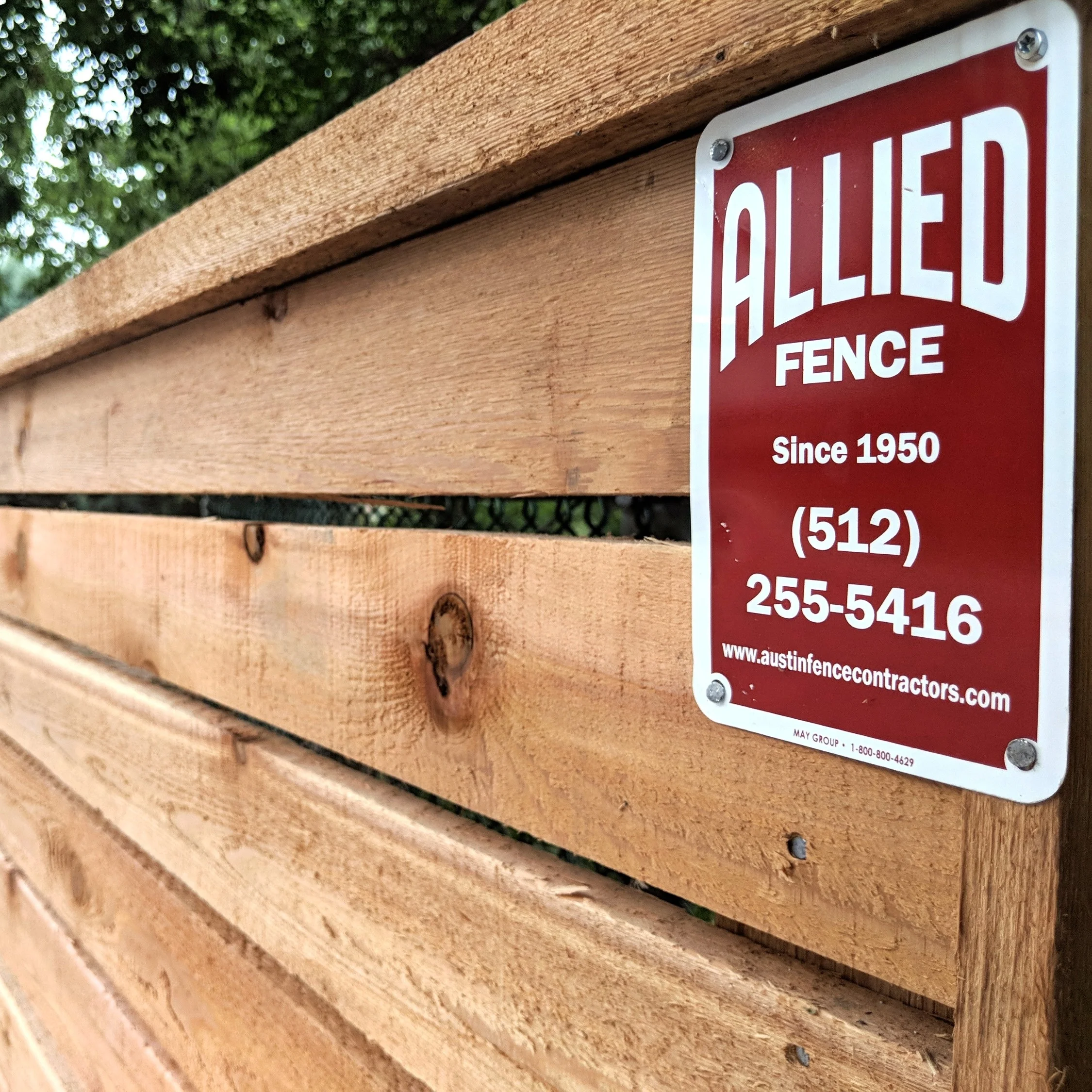 Allied Fence sign reading Since 1950 mounted on a new cedar horizontal fence